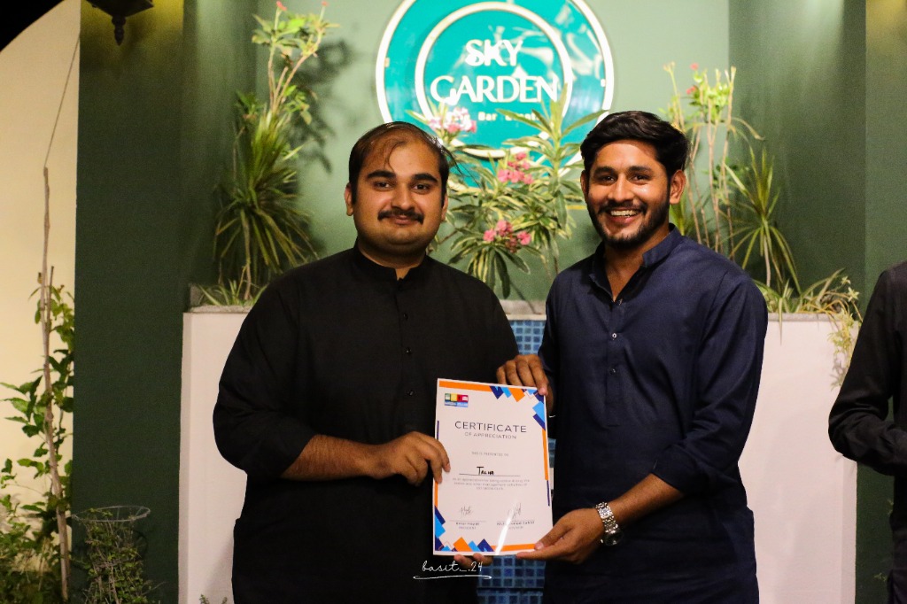 Talha receiving Certificate of Appreciation at UET Media Club